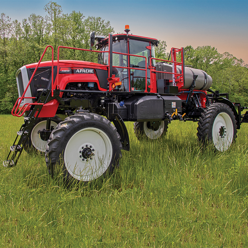 side of apache sprayer sitting in tall grass